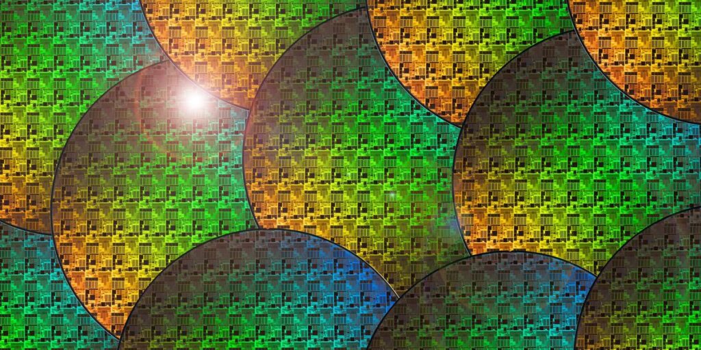 Layered Rendering Of Colorful Semiconductor Wafers With A Bright White Light Sitting On One.jpg