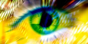 Blurry Close Up Image Of A Green Eye With A Yellow Background.jpg