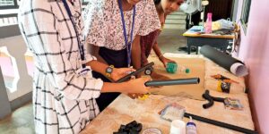 1707529579 A Group Of Young Girls Working On A Project Together Involving Black Rods.jpg