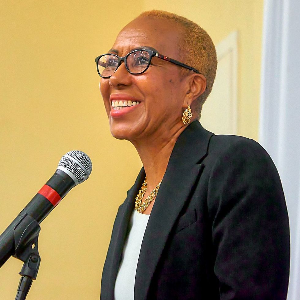 a smiling woman with short hair and glasses